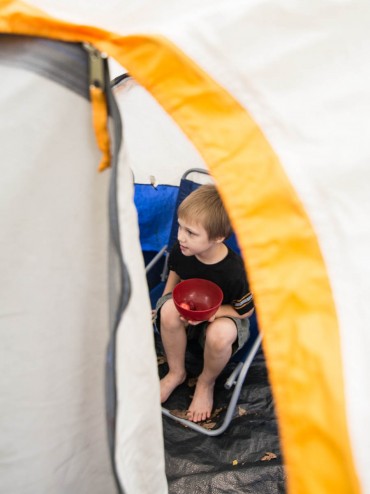 Luke took a break to enjoy a bit of a snack, but was riveted to the game going on outside the tent.